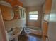 This tiled bathroom offers a sink, toilet, tub and storage at 3516 Ridgemont Rd, Orlando, FL 32808