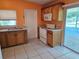 Functional kitchen featuring appliances and a door leading to the patio at 3516 Ridgemont Rd, Orlando, FL 32808