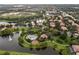 An expansive aerial shot captures a large community pool and playground near a lake with many homes at 390 Anessa Rose Loop, Ocoee, FL 34761