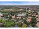 A panoramic aerial shot reveals houses with mature trees, a lake and fountain, and community amenities at 390 Anessa Rose Loop, Ocoee, FL 34761