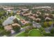 From above, homes, tree-lined streets, and a lake with a fountain offer a picturesque neighborhood view at 390 Anessa Rose Loop, Ocoee, FL 34761