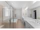Luxurious bathroom with double vanity, soaking tub, glass-enclosed shower, and neutral tile at 390 Anessa Rose Loop, Ocoee, FL 34761