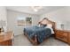 Charming bedroom with hardwood furnishings, a comfortable bed, and natural light at 390 Anessa Rose Loop, Ocoee, FL 34761