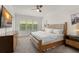 Bright bedroom with large windows, plantation shutters, and a king-sized bed at 390 Anessa Rose Loop, Ocoee, FL 34761