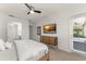 Bedroom with TV, natural light, and access to outdoor area with blinds at 390 Anessa Rose Loop, Ocoee, FL 34761