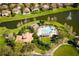 Aerial view of community pool, clubhouse, playground, and lake with fountain surrounded by well-maintained landscaping at 390 Anessa Rose Loop, Ocoee, FL 34761