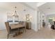 Formal dining room with modern chandelier, wood table, and elegant decor at 390 Anessa Rose Loop, Ocoee, FL 34761