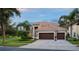 Beautiful two-story home with a tile roof, three-car garage, and landscaped front yard at 390 Anessa Rose Loop, Ocoee, FL 34761