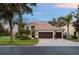 Stunning two-story home featuring a tile roof, three-car garage, and lush landscaping at 390 Anessa Rose Loop, Ocoee, FL 34761