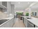 Bright kitchen with stainless steel appliances, countertops, and an adjacent dining area at 390 Anessa Rose Loop, Ocoee, FL 34761