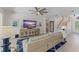 Bright living room featuring a large TV, comfortable sofa, and eye-catching blue patterned rug at 390 Anessa Rose Loop, Ocoee, FL 34761