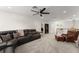 Spacious living room features plush carpeting, a ceiling fan, and comfortable seating arrangements at 390 Anessa Rose Loop, Ocoee, FL 34761