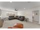 Open-concept living room featuring a large sectional sofa, side tables and neutral carpeting at 390 Anessa Rose Loop, Ocoee, FL 34761