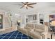 Open floor plan living room with a large sofa, staircase, and view of the modern kitchen at 390 Anessa Rose Loop, Ocoee, FL 34761