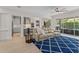 Open-concept living room featuring a plush sofa, stylish rug, and seamless access to the kitchen at 390 Anessa Rose Loop, Ocoee, FL 34761