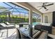 Outdoor patio with a dining table, lounge chairs, and a clear view of the pool and landscaping at 390 Anessa Rose Loop, Ocoee, FL 34761