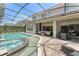 Covered patio with comfortable seating, an outdoor dining area, and a view of the pool and spa at 390 Anessa Rose Loop, Ocoee, FL 34761