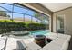 Relaxing outdoor space with a pool, spillover spa, and a cozy fire pit area with plush seating at 390 Anessa Rose Loop, Ocoee, FL 34761