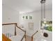 Bright foyer staircase with modern chandelier and windows that flood the space with natural light at 390 Anessa Rose Loop, Ocoee, FL 34761