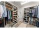 Organized walk-in closet features custom shelving for shoes and clothes racks for ample storage space at 390 Anessa Rose Loop, Ocoee, FL 34761