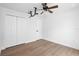 Bedroom featuring hardwood floors, closet, and ceiling fan at 4102 Boca Woods Dr, Orlando, FL 32826