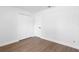 Bedroom with hardwood floors, closet, and white trim at 4102 Boca Woods Dr, Orlando, FL 32826