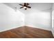 Bright bedroom with a ceiling fan, hard wood floors, and a large window at 4102 Boca Woods Dr, Orlando, FL 32826