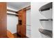 Walk in closet with custom wood shelving and storage at 4102 Boca Woods Dr, Orlando, FL 32826