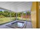 Relaxing screened in hot tub room with views of the lush yard at 4102 Boca Woods Dr, Orlando, FL 32826