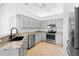 Modern kitchen featuring gray cabinets, granite countertops, and stainless steel appliances at 4102 Boca Woods Dr, Orlando, FL 32826