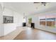 Open-concept living room with tile and wood floors, bright windows, and modern lighting at 4102 Boca Woods Dr, Orlando, FL 32826