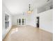 Bright living room with tile flooring, high ceilings, and natural light from large windows and french doors at 4102 Boca Woods Dr, Orlando, FL 32826