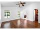 Spacious main bedroom featuring wood floors, a ceiling fan, and ensuite bathroom at 4102 Boca Woods Dr, Orlando, FL 32826