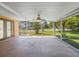 Wide screened patio with ceiling fan overlooking the manicured lawn and neighborhood at 4102 Boca Woods Dr, Orlando, FL 32826