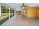 Spacious screened patio featuring a ceiling fan and views of the green backyard at 4102 Boca Woods Dr, Orlando, FL 32826