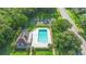 Community pool with tennis court, clubhouse, and landscaped surroundings at 4102 Boca Woods Dr, Orlando, FL 32826