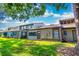 A view of the condo's exterior with well-maintained grass and trees at 458 Meadowood Blvd, Fern Park, FL 32730