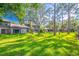 Landscaped backyard featuring a spacious lawn and mature trees at 458 Meadowood Blvd, Fern Park, FL 32730