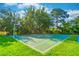 Outdoor basketball court surrounded by lush greenery and trees at 458 Meadowood Blvd, Fern Park, FL 32730