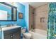 Updated bathroom featuring blue walls and a shower/tub combination at 458 Meadowood Blvd, Fern Park, FL 32730