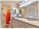 Bright bathroom with a spacious vanity and a shower with orange curtains at 458 Meadowood Blvd, Fern Park, FL 32730