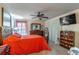 Cozy bedroom with carpet, neutral paint, TV, and ceiling fan at 458 Meadowood Blvd, Fern Park, FL 32730