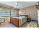 Bedroom featuring a comfortable bed, side table, and a window with blinds at 458 Meadowood Blvd, Fern Park, FL 32730