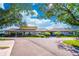 A view of the clubhouse with well-maintained landscaping and parking at 458 Meadowood Blvd, Fern Park, FL 32730