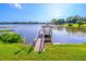 Picturesque view of a dock extending into a serene lake, offering a peaceful spot to enjoy the waterfront at 458 Meadowood Blvd, Fern Park, FL 32730