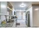 Bright kitchen features stainless appliances, granite counters, white cabinetry and pantry at 458 Meadowood Blvd, Fern Park, FL 32730