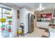 Well-lit kitchen space with stainless steel refrigerator, white cabinetry, and stylish decor at 458 Meadowood Blvd, Fern Park, FL 32730
