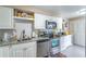 Kitchen with stainless steel appliances, granite countertops and white cabinets at 458 Meadowood Blvd, Fern Park, FL 32730