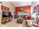 Inviting living room with comfortable seating, a wooden console table and a bright accent wall at 458 Meadowood Blvd, Fern Park, FL 32730