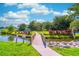 Scenic view of the community playground area and small pond at 458 Meadowood Blvd, Fern Park, FL 32730
